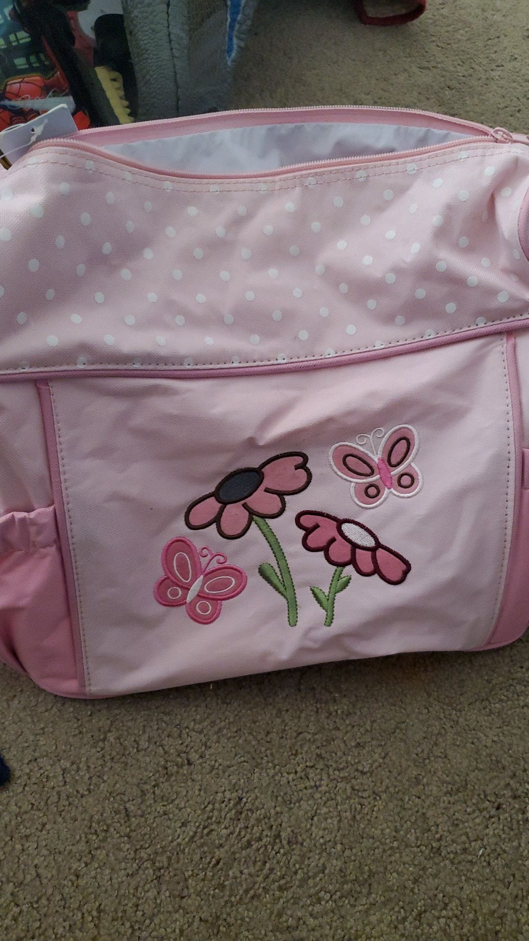 Pink baby girl carrying diaper bag