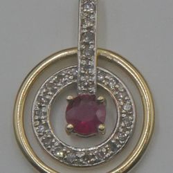 14kt yellow gold pendant w 27 diamonds 0.15pts  and ruby 0.25pts  2.7 grams . circle spins. 875202-1.