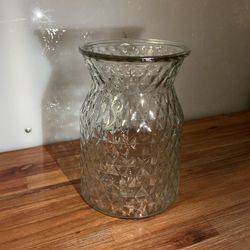 This is a clear glass vase with a geometric diamond pattern design.
