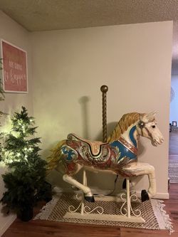 Fancy carousel style decorator horse on an iron scroll base