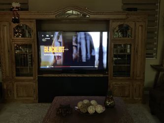 Medium oak entertainment center will hold up to 70 inch TV or larger lots of storage or CDs and DVDs