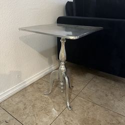 Brushed aluminum side table with sculpted metal pedestal base