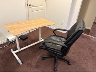 Defining wheels with black office chair. Desk is adjustable in height.