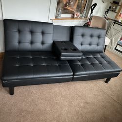 Black leather futon couch with charging port