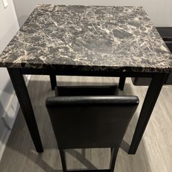 Black marble look dining table with 1 chair