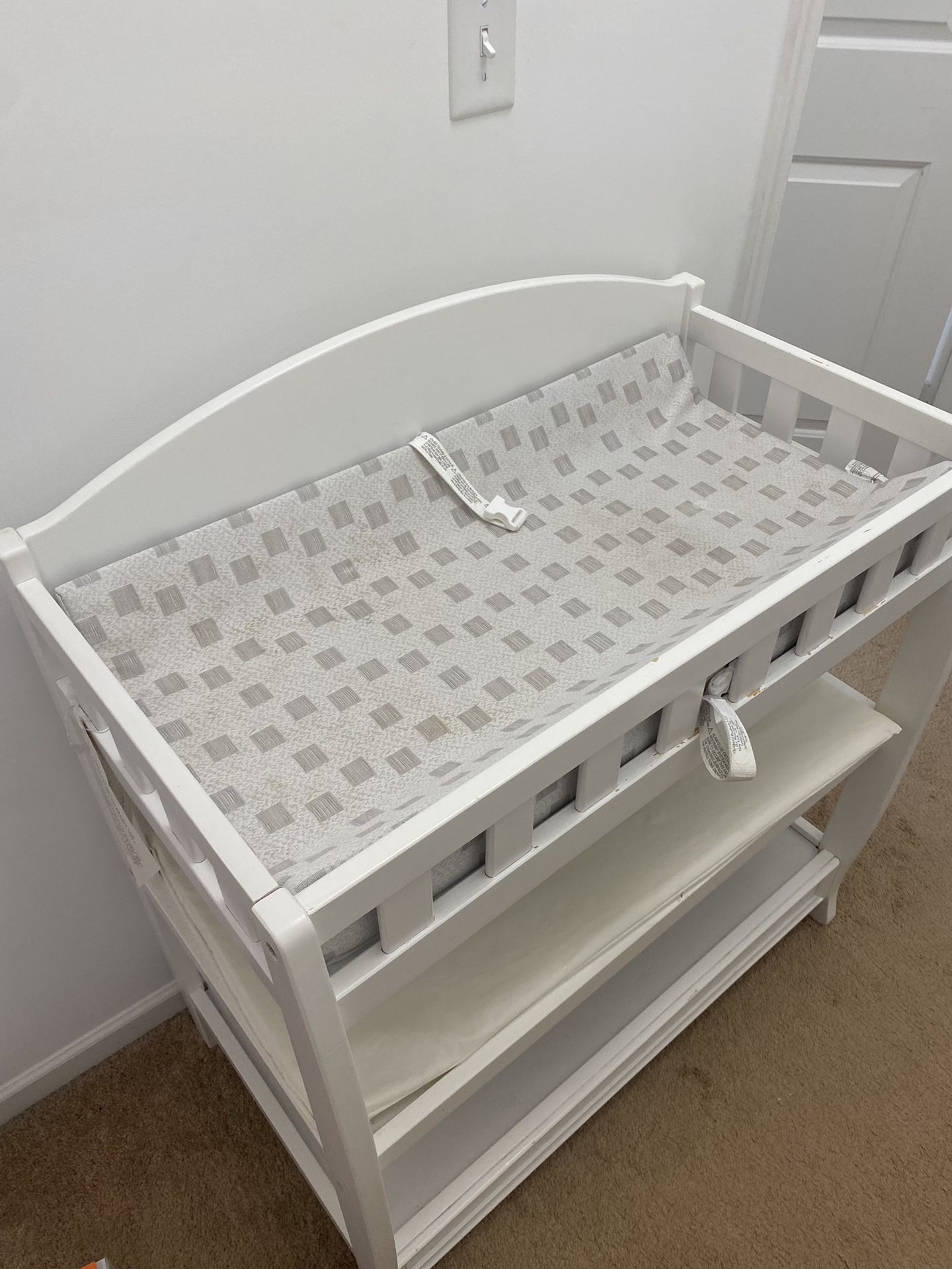 White diaper changing table with diaper changing pads