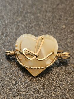 This is a vintage gold-filled heart brooch 