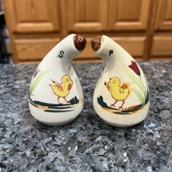 Vintage Mid-Century pair of salt and pepper shakers. Size approximately 3 1/2 inches tall. Preowned. Has been on display in a cabinet with a very l
