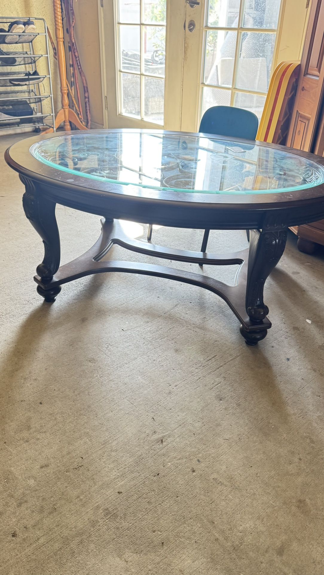 Elegant Oval Coffee Table – Wood & Glass with Metal Scroll Design