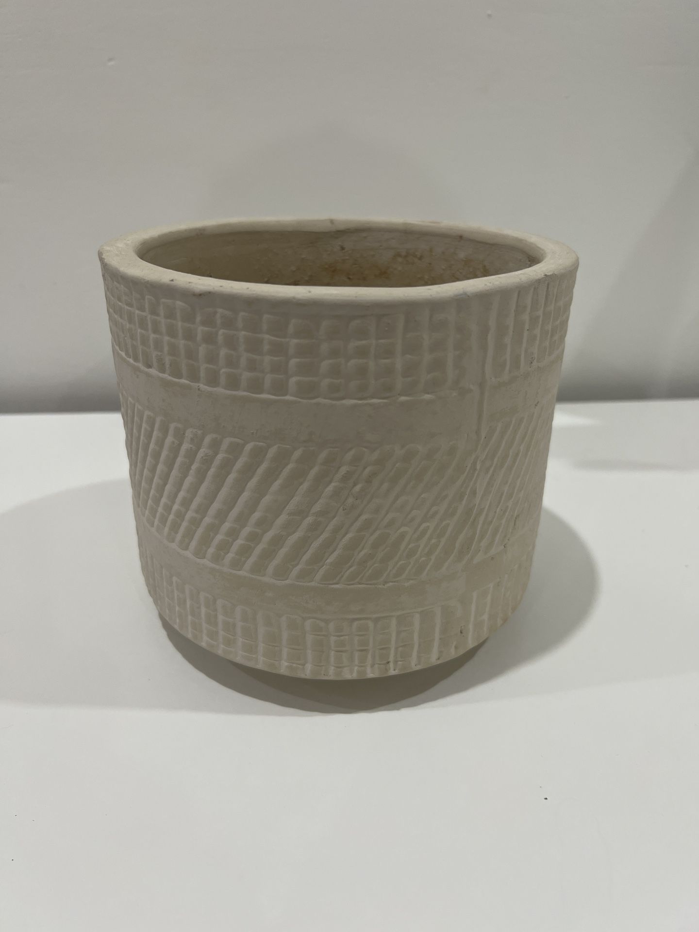 Cream-colored ceramic plant pot