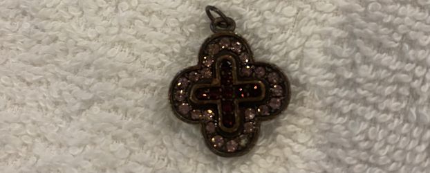 Cross pendant with pink and red gemstones