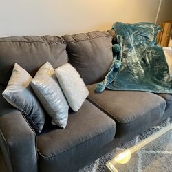 Gray three seater sofa with queen pull out bed