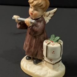 Vintage NAPCOWARE boy angel figurine playing a flute with presents nearby, H3”