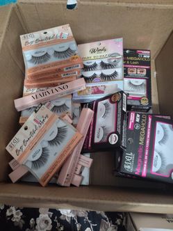 Box full of eye lashes and eyebrow pencil