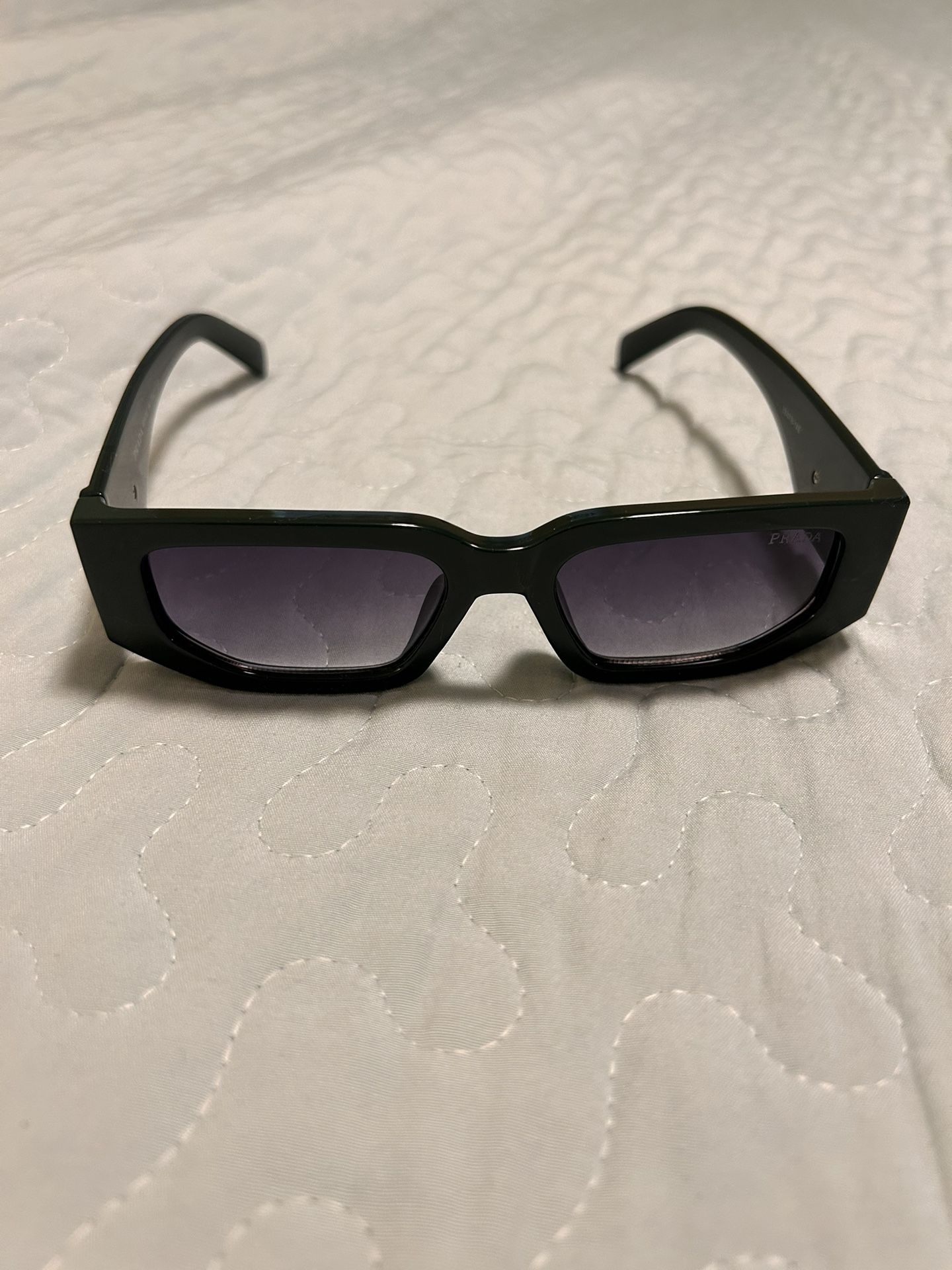 Prada PR 17WS “Symbole” sunglasses, specifically the Verde (green) version.