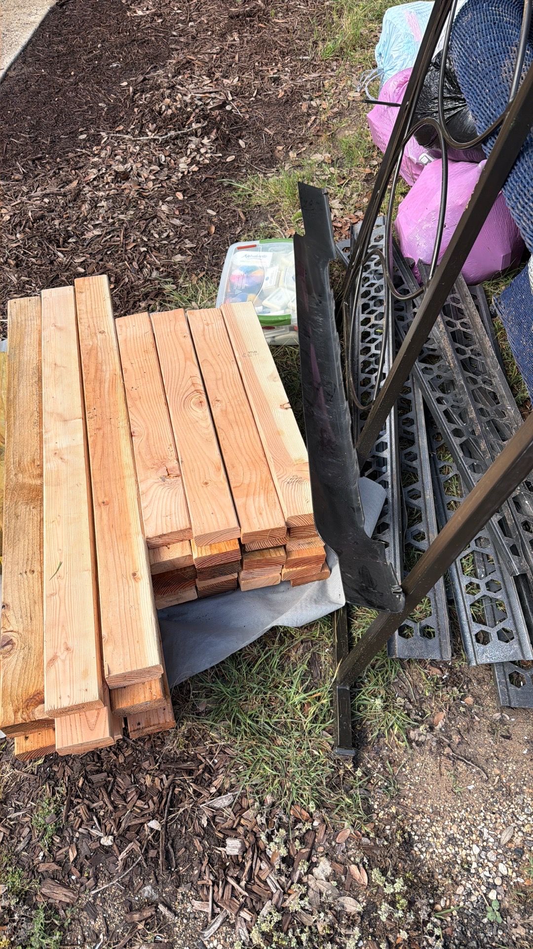 Stack of cut 2x4’s and metal shelving pieces