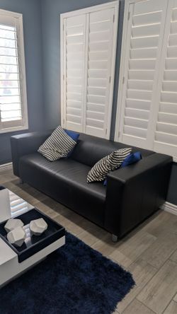 Black leather sofa and cushions in excellent condition