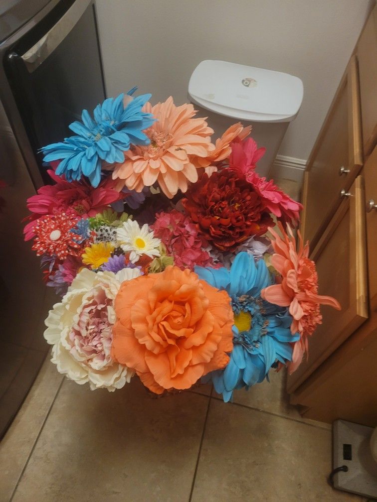 Vibrant mix of artificial flowers in various colors.