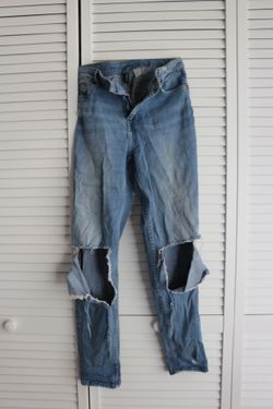 High-waisted, straight-leg blue jeans with a distressed look