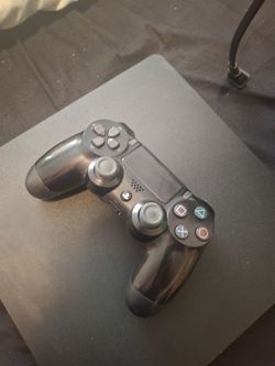 PS4 console w/ silicon biohazard controller skin and a charging station