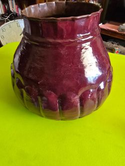 Copper pot painted burgundy on the outside. Still Copper on the inside.