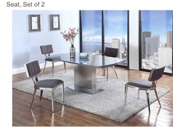 Modern dining chair featuring a charcoal grey upholstered seat and backrest with a polished silver-colored metal frame -  Set of 2