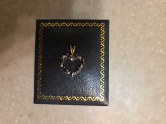 14 k gold Sapphires And diamonds pendant.  Weight is 1.3 grams