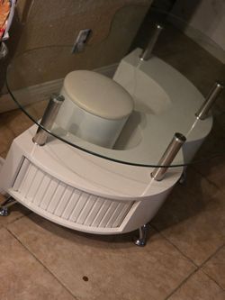 Coffee table with slide under stools