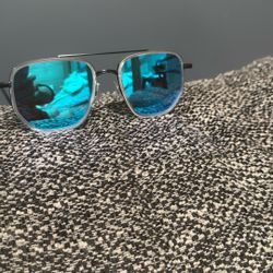 This is a pair of DITA Flight 006 sunglasses with a silver frame and blue mirror lenses. 