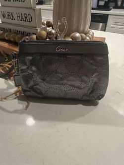 Coach Madison perforated liquid gloss wristlet.