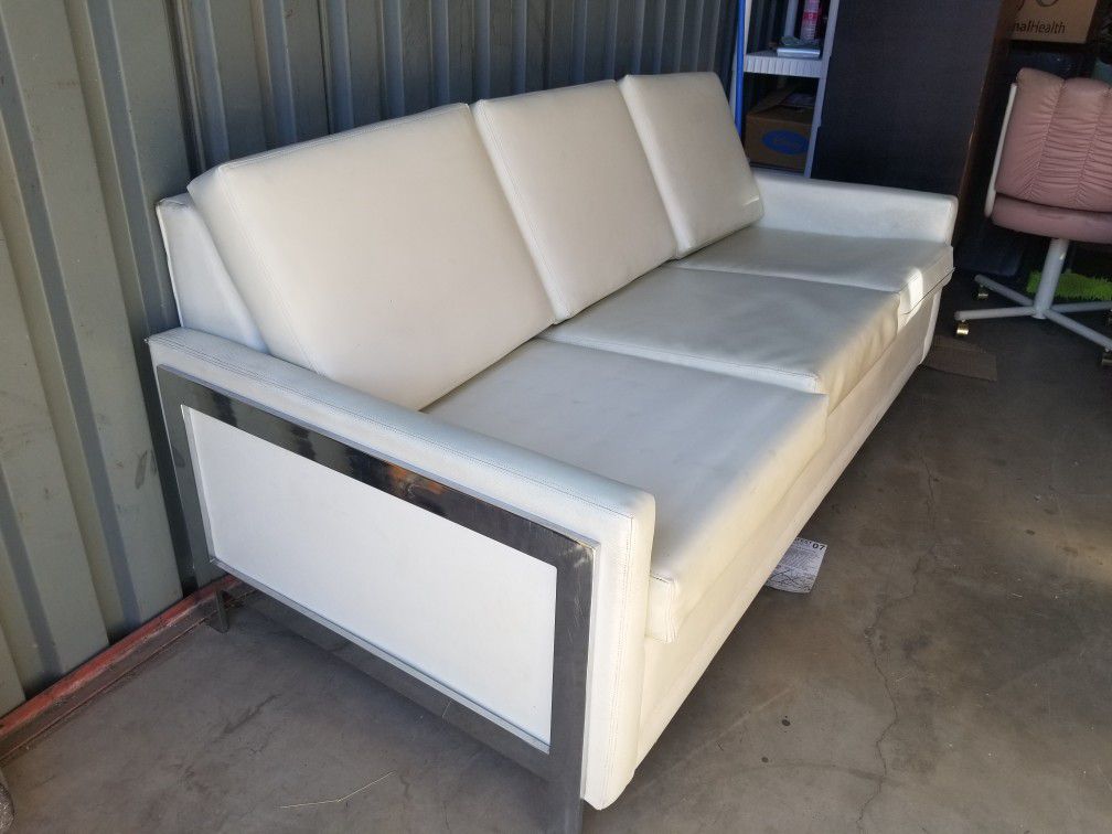 White leather sleeper sofa / couch with chrome side supports