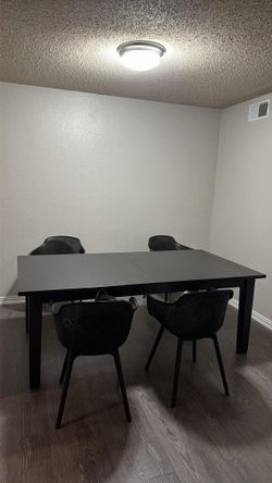 Black dining table with chairs
