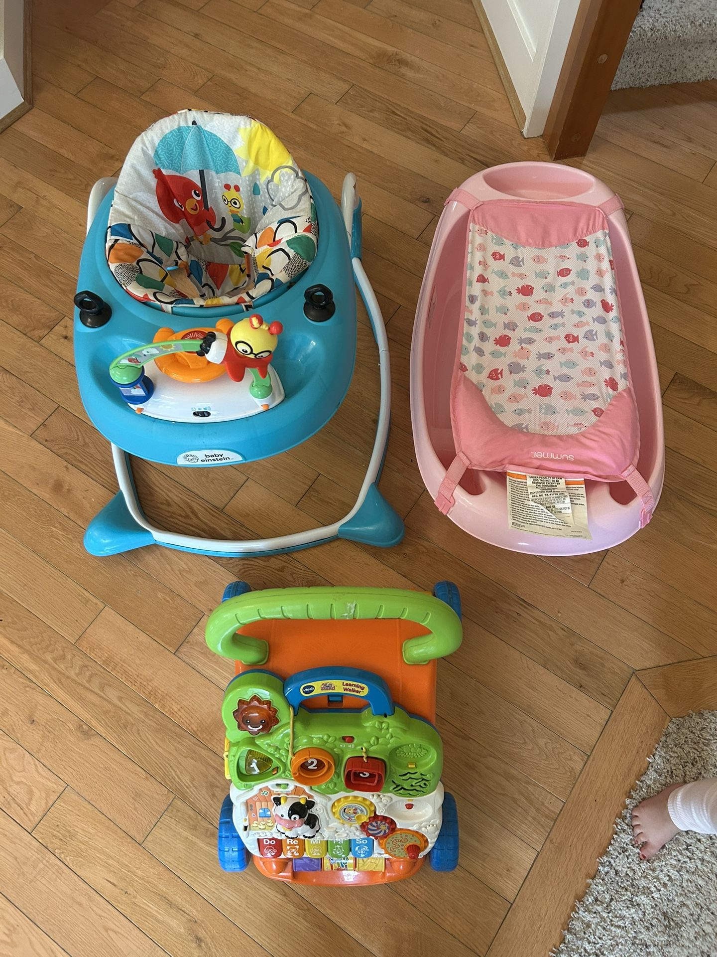 Two baby walkers, one bath All in good condition 