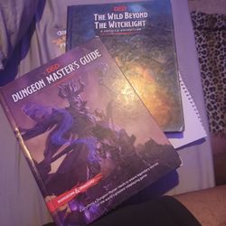 D&D Dungeon Masters Guide And The Wild Beyond The Witchlight Adventure Guide. 