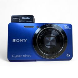 Sony CyberShot DSC-W690 16.1MP Digital Camera Bundle Blue w/ Charger + Battery  Comes with: Camera Charger Battery Wrist Strap  *Battery door does not