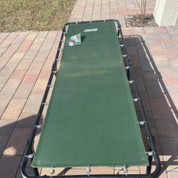 Folding Coleman camping cot with cushion