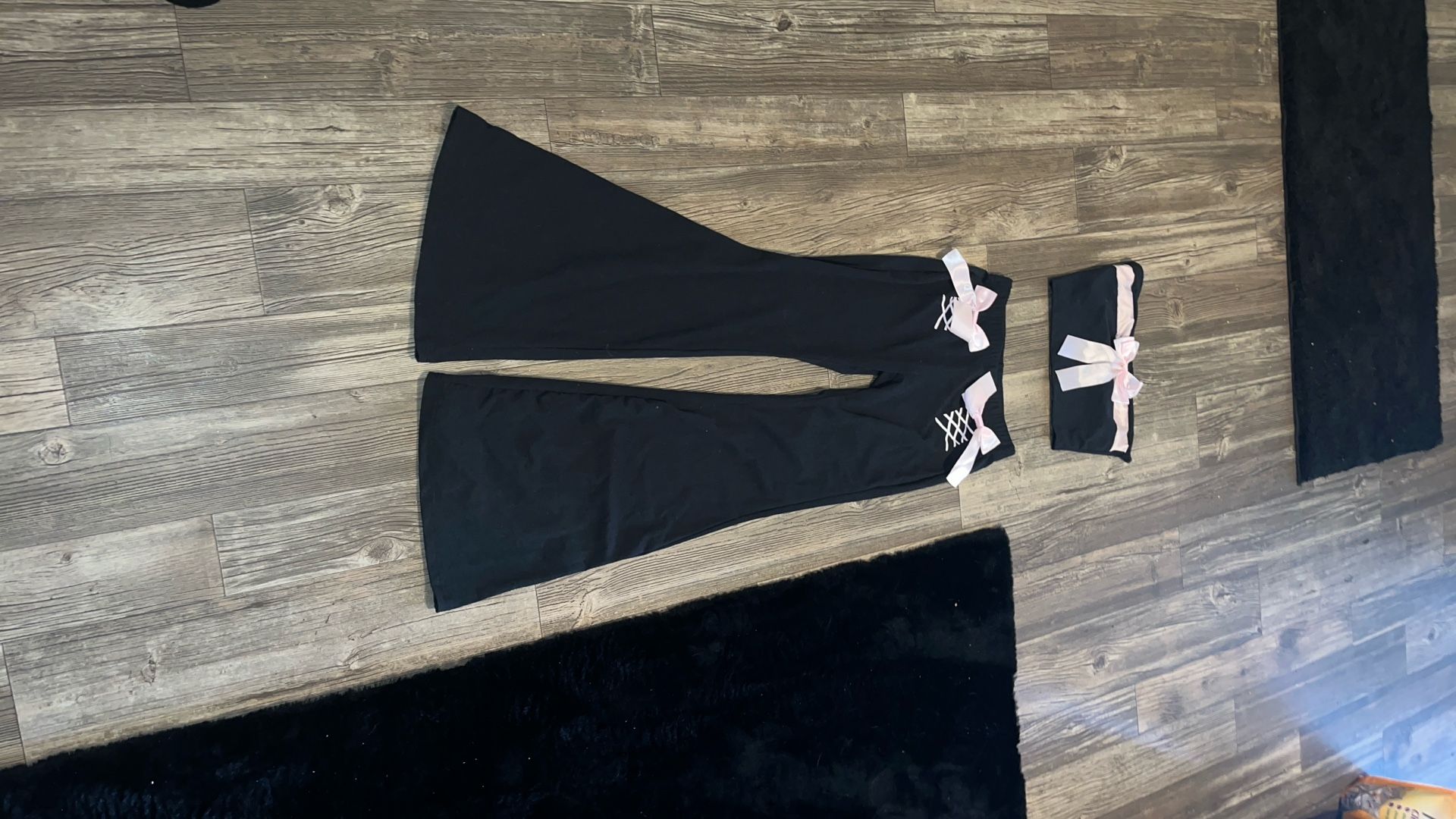 black and pink outfit with bows