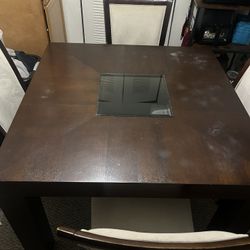 Wooden dining room table with four chairs