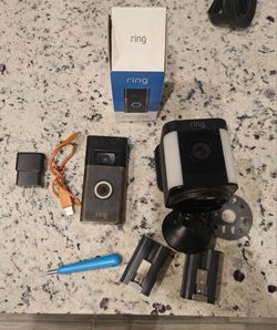 Ring doorbell camera with mounting equipment and outdoor spotlight camera