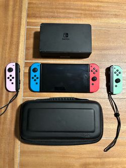 Nintendo Switch with protective case and extra controllers