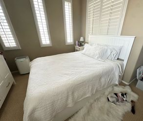 Barely used newer, beautiful, quern white headboard, bed with storage