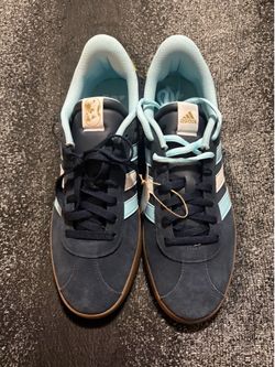 Navy blue adidas with sky blue stripes