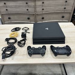 Sony PlayStation 4 Pro CUH-7215B 1TB game console with two joysticks 