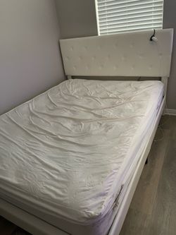 Queen bed with new mattress with protection cover