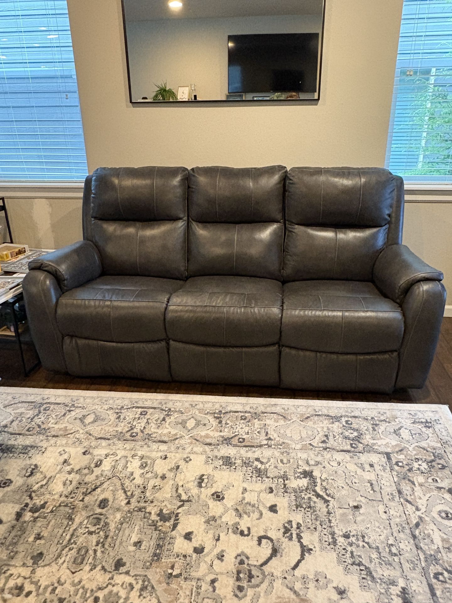 Leather two Recliner sofa. Purchased one year ago hardly used. Two photos show minor scratches.