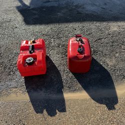 Two boat gas tanks one metal one plastic
