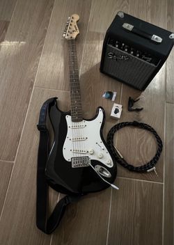 Squier guitar with amp and accessories