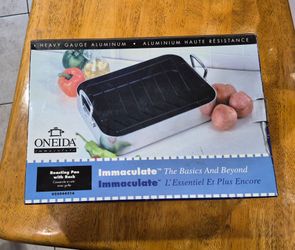 Oneida Immaculate heavy-gauge aluminum roasting pan with rack featuring a dark textured non-stick interior.
