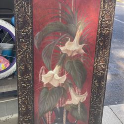 decorative framed canvas print featuring red flowers in a black vase
