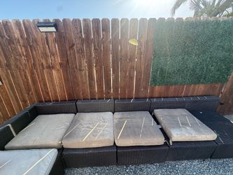 USED Dark brown five piece weave outdoor sectional seats with some cushions
